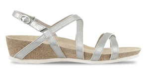 Tarifa in silver metallic is a feminine modern strappy sandal with velcro buckle.&nbsp; Built on a new wedge with a contoured cork footbed.