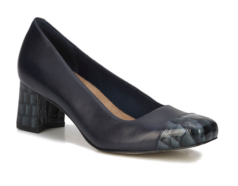 The perfect comfort heel with added pizazz! Mira in navy is a lovely cap toe pump designed with an on-trend slightly squared tapered toe and notched block heel. This all-day style is further enhanced by ultra-cushioned Tiny Pillows insoles wrapped in soft micro fiber sueded fabric.