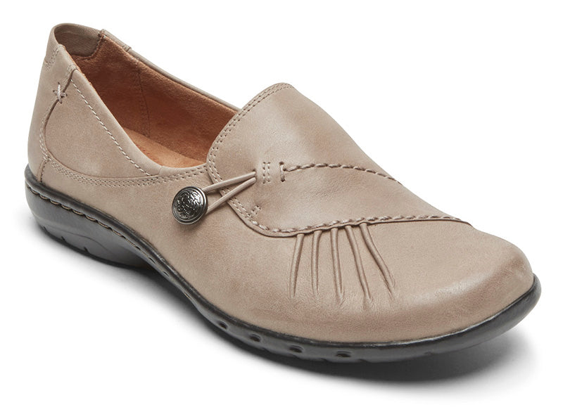 Sometimes you just need a good solid shoe for all-­day comfort. But what about all-around style? This Cobb Hill modern slip on has it all with asymmetrical ruching over the top and an antique metal button with bungee clasp for an ever so fashionable fit. The heel height is 1.25 inches