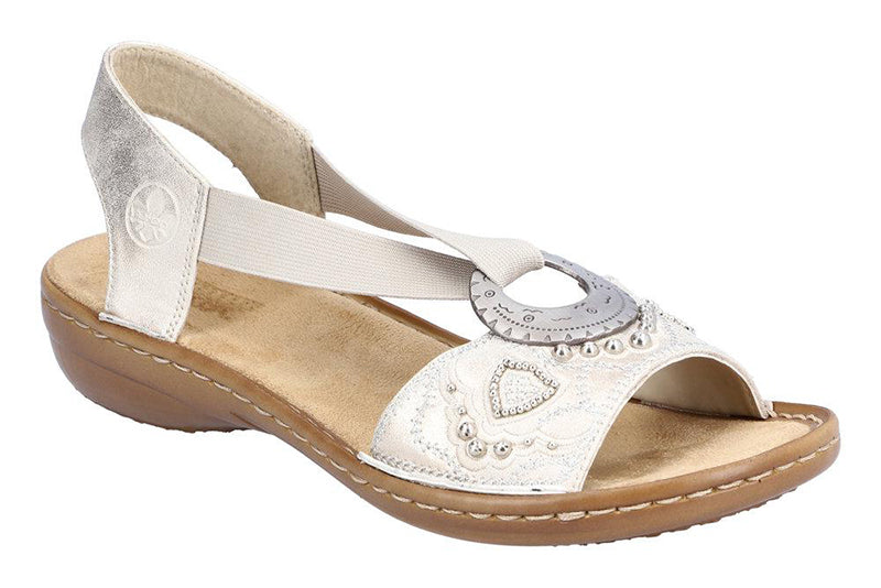 The Rieker light gold Regina B9 sandal is fun.  This lightweight, extra flexible sandal encourages natural motion and makes it easy to be on your feet all day long.  Features a leather upper with a decorative design.  Elastic straps allow for a personalized fit.  The heel height is approximately 1 inch.