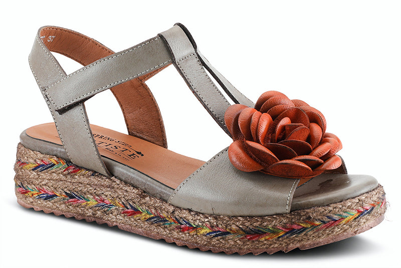 Tempest is a  French inspired brushed leather quarter strap sandal featuring a multi-color jute wrapped wedge with an adjustable hook and loop closure ankle strap, a well padded insole and a decorative 3 dimentional flower.